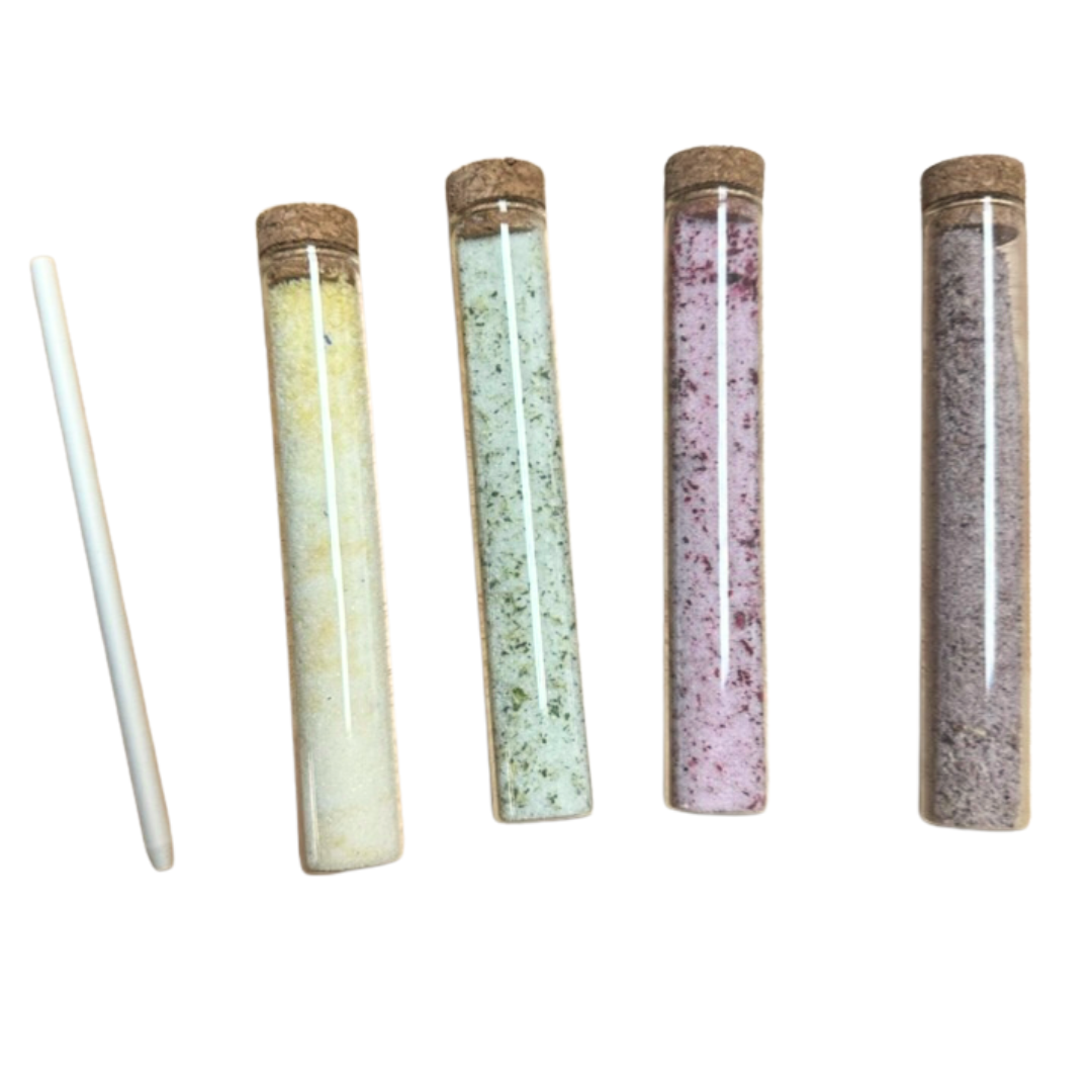 Sugar Floral Tubes with mulberry, bachelor button, mint, and roselle hibiscus sugars in glass tubes with a stir stick.
